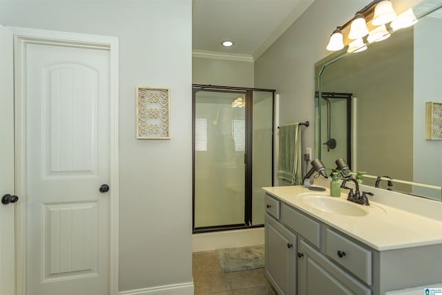 bathroom featuring ornamental molding, a stall shower, tile patterned flooring, and vanity