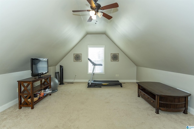 exercise room with vaulted ceiling, carpet, and baseboards