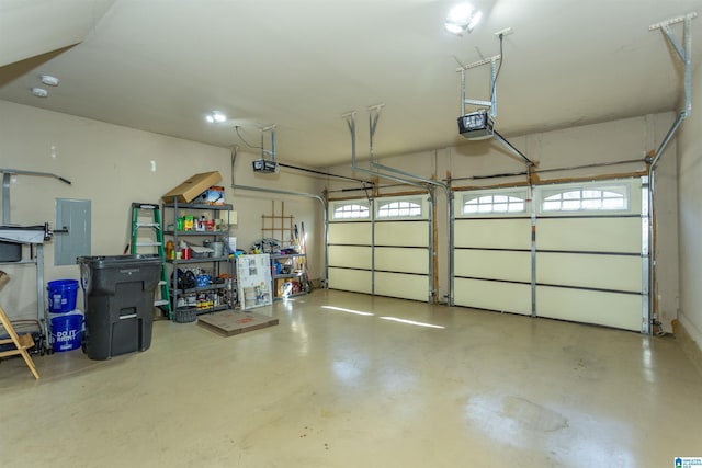 garage with electric panel and a garage door opener