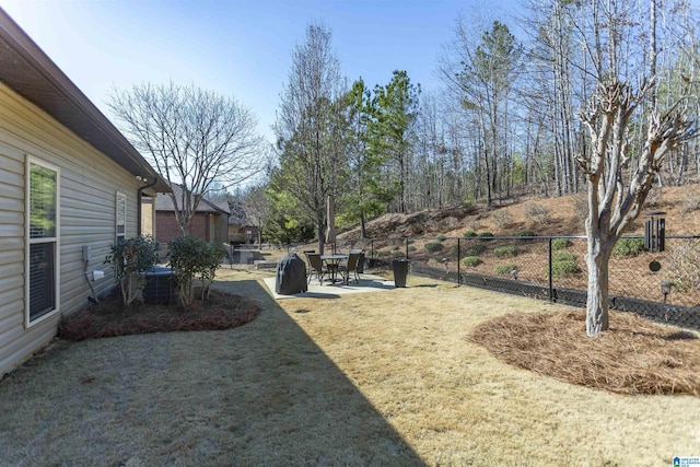 view of yard featuring central air condition unit, fence, and a patio