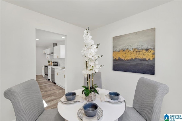 dining area with light wood-style flooring