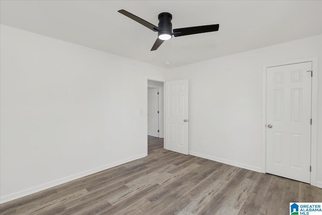 unfurnished bedroom with light wood-style floors, baseboards, and a ceiling fan