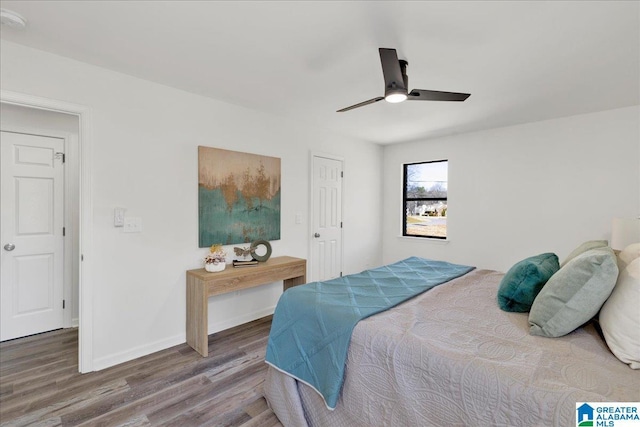 bedroom with wood finished floors, a ceiling fan, and baseboards