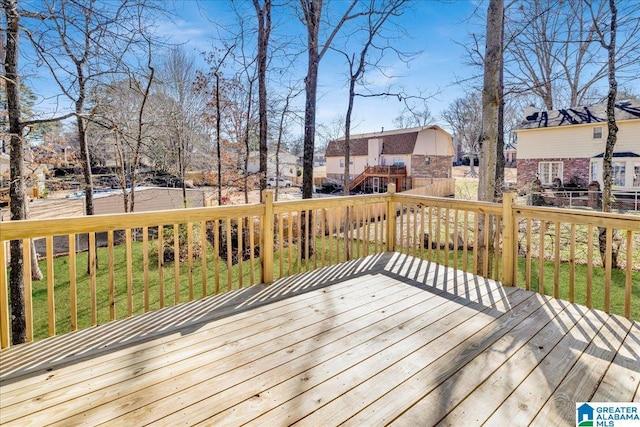 deck with a residential view, fence, and a yard