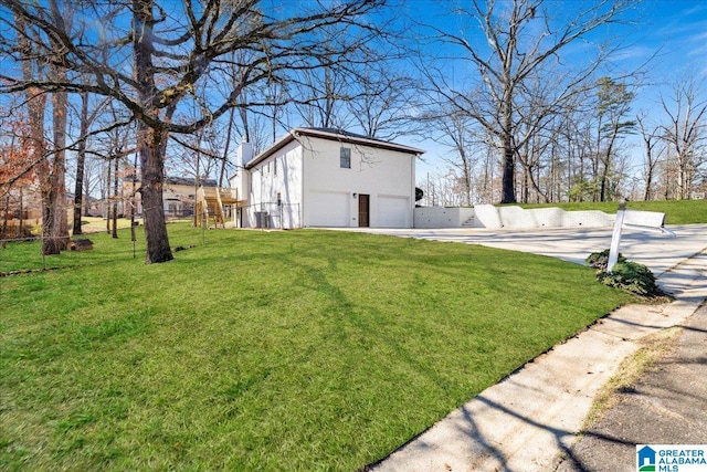 view of yard with concrete driveway and an attached garage