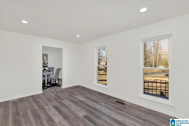 interior space with visible vents, baseboards, wood finished floors, and recessed lighting