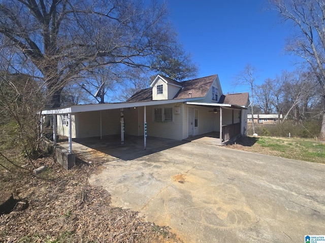 view of home's exterior with an attached carport and concrete driveway