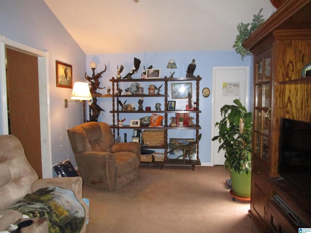 carpeted living area featuring vaulted ceiling