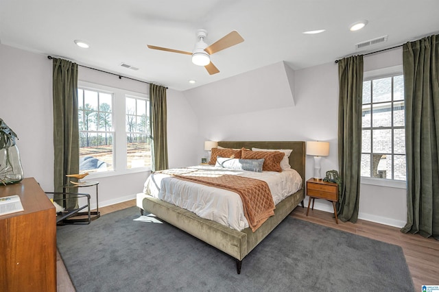 bedroom featuring dark wood-style floors, multiple windows, and visible vents