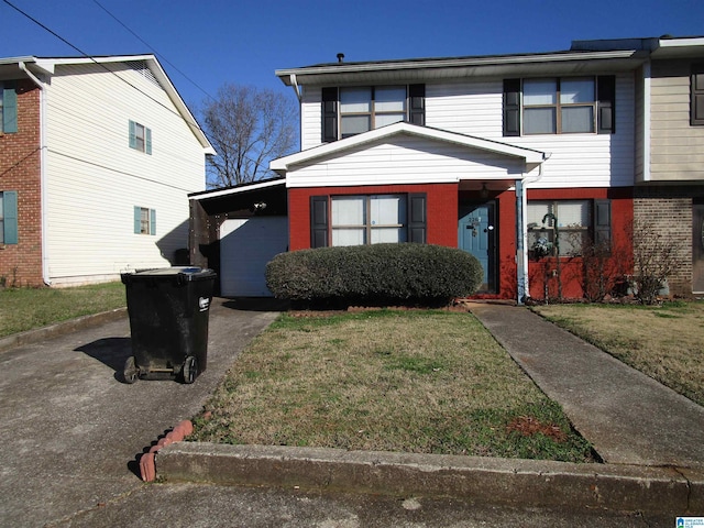 view of front of house with driveway, brick siding, and a front lawn