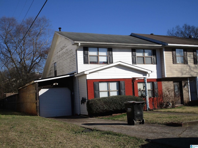 view of front of home with driveway, an attached garage, a front lawn, and brick siding