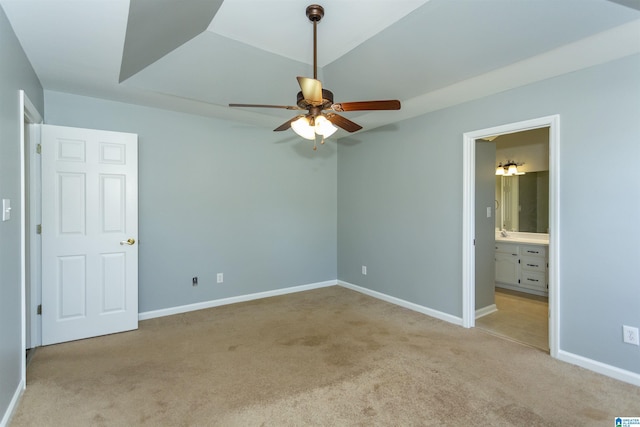 unfurnished bedroom with light carpet, connected bathroom, and baseboards