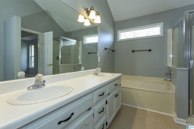 full bath with a stall shower, tile patterned flooring, a sink, and a bath