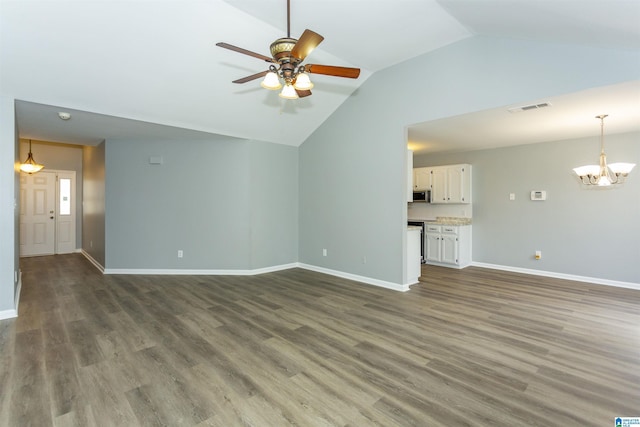 unfurnished living room with baseboards, visible vents, lofted ceiling, wood finished floors, and ceiling fan with notable chandelier