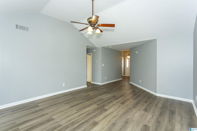 empty room featuring ceiling fan, lofted ceiling, wood finished floors, visible vents, and baseboards