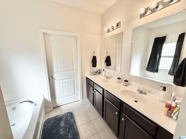 bathroom with a sink, double vanity, tile patterned flooring, and a bath