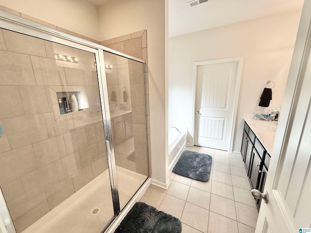 bathroom featuring visible vents, vanity, a shower stall, a bath, and tile patterned floors