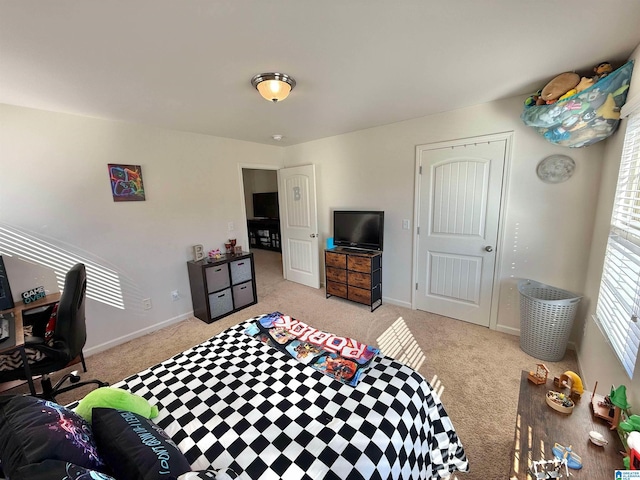 bedroom with baseboards and light colored carpet