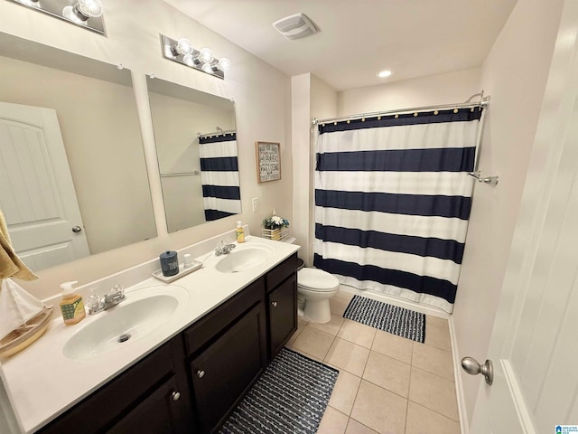 full bathroom featuring double vanity, tile patterned flooring, visible vents, and a sink