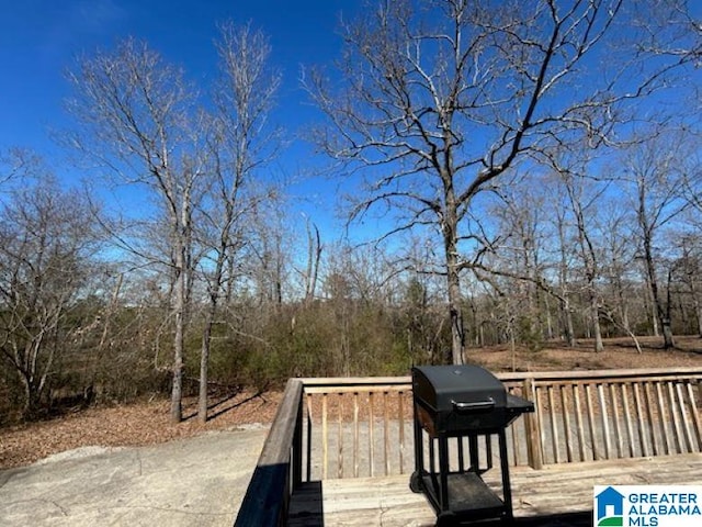 wooden deck featuring a grill