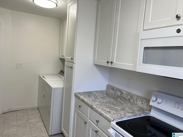 laundry area featuring laundry area, independent washer and dryer, and baseboards