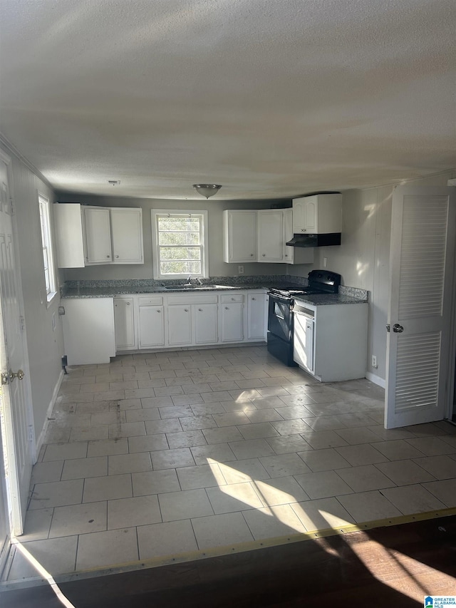 kitchen featuring white cabinets, black electric range oven, a sink, and a textured ceiling