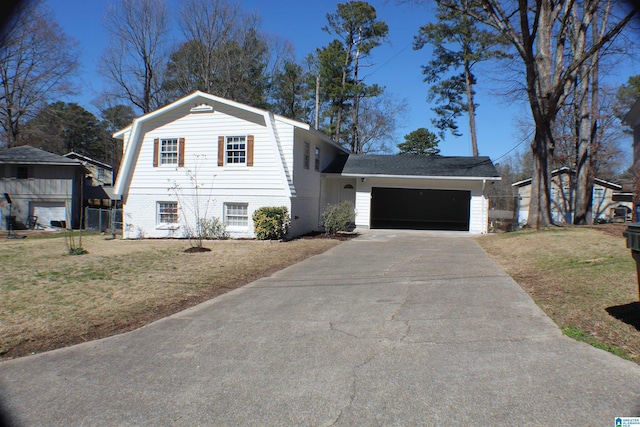 view of front of house featuring a garage, driveway, a front yard, and a gambrel roof