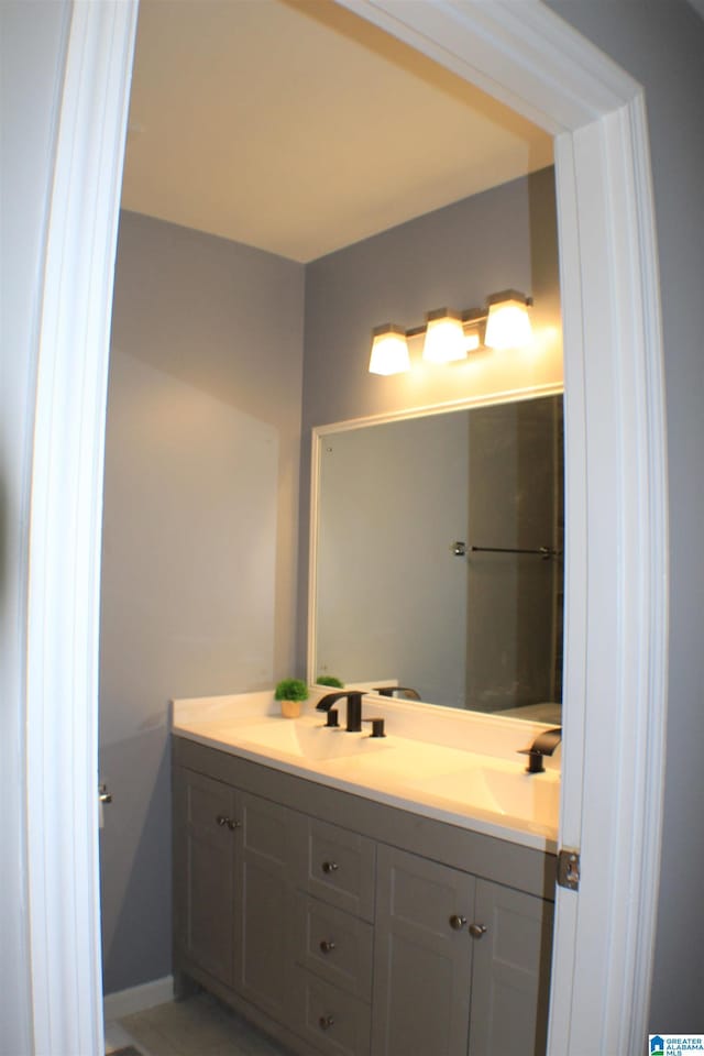 417 Argonne Dr NE, Center Point, AL 35215 - bathroom featuring double vanity, baseboards, and a sink
