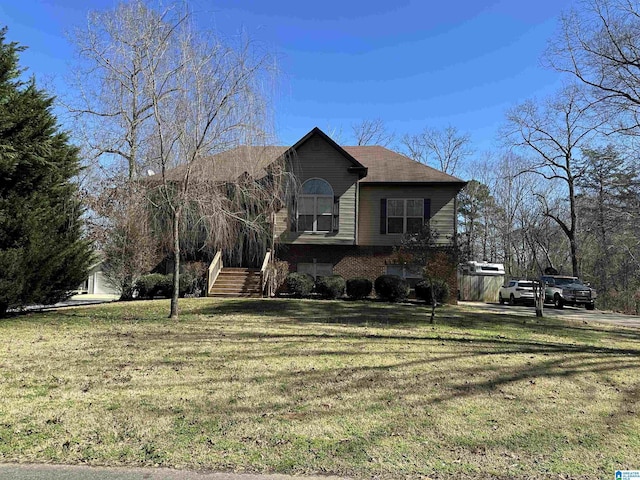 view of front of property with a front lawn and brick siding