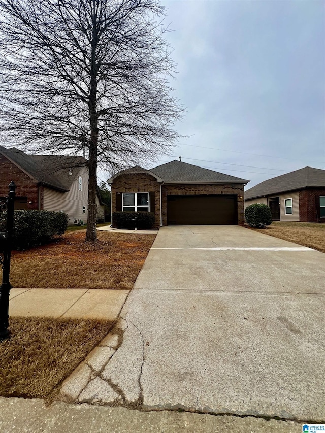 single story home featuring a garage, a shingled roof, concrete driveway, and brick siding