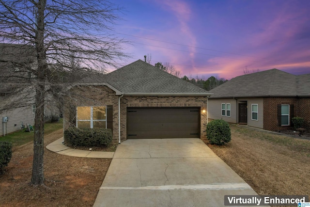 view of front of house featuring a garage, concrete driveway, brick siding, and roof with shingles