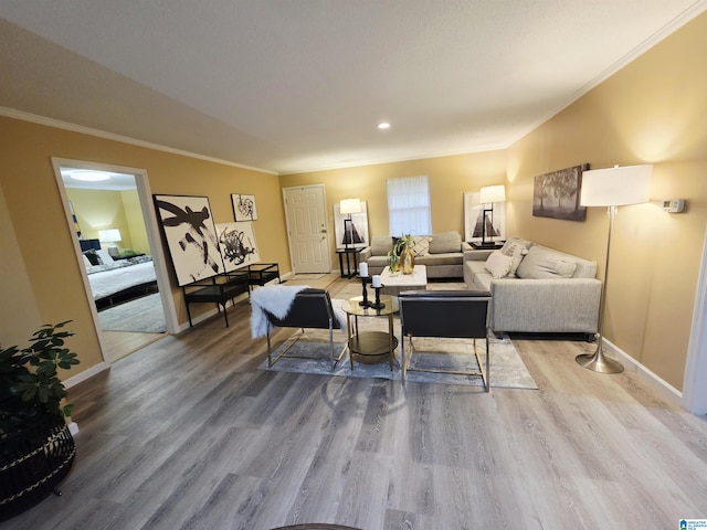 living room with baseboards, crown molding, and wood finished floors