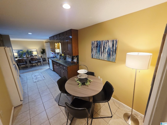 dining space featuring light tile patterned flooring, baseboards, and recessed lighting