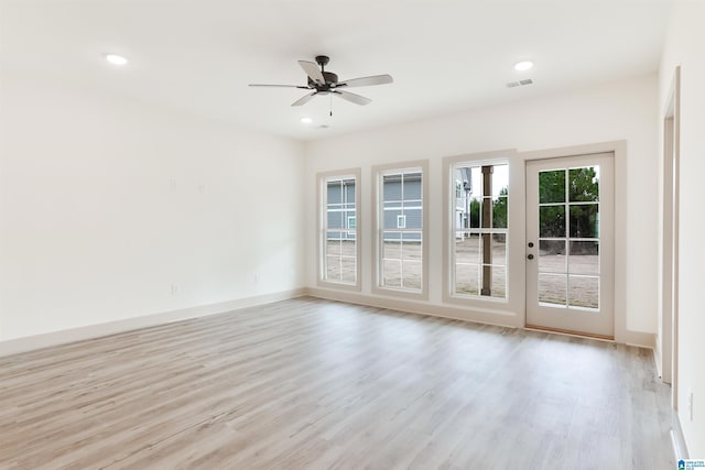 empty room with visible vents, baseboards, a ceiling fan, light wood-style flooring, and recessed lighting