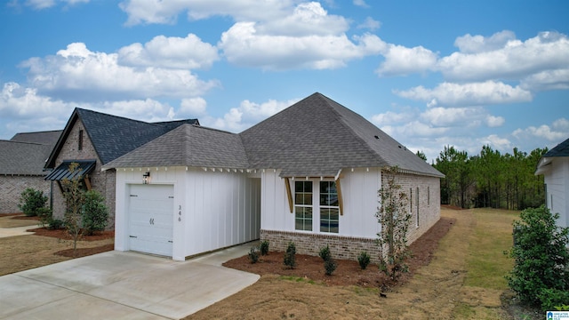 view of front of house featuring driveway, brick siding, roof with shingles, and an attached garage