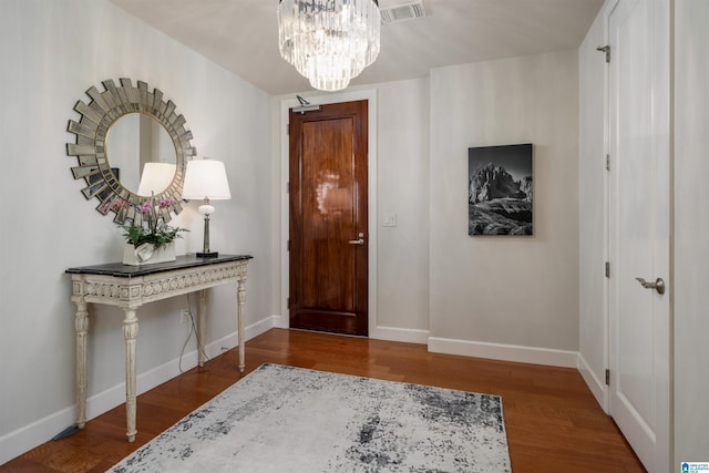 foyer with visible vents, baseboards, and wood finished floors