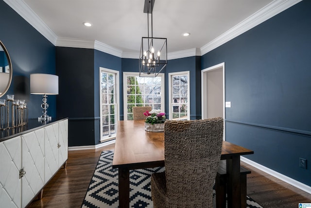 dining space featuring a chandelier, wood finished floors, and crown molding