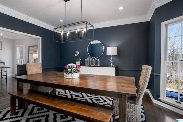 dining space featuring a chandelier, recessed lighting, wood finished floors, baseboards, and ornamental molding