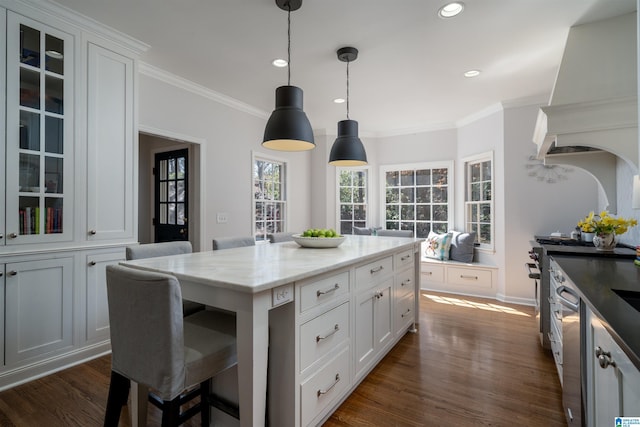 kitchen with dark wood-style floors, white cabinetry, glass insert cabinets, and premium range hood