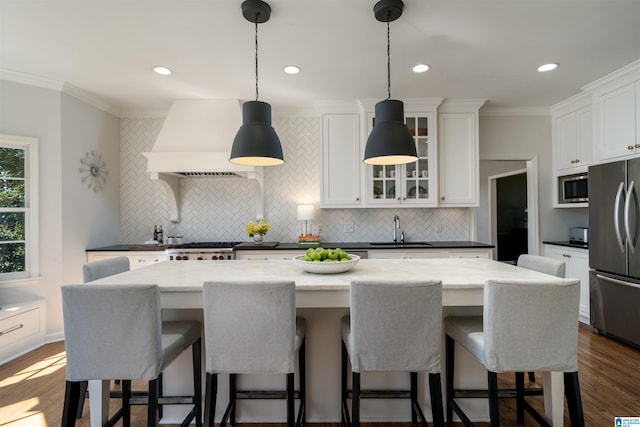 kitchen featuring premium range hood, dark wood-style flooring, a sink, white cabinets, and appliances with stainless steel finishes