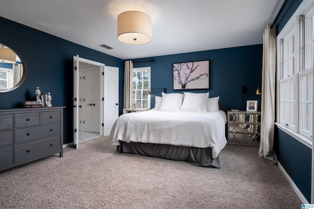 bedroom with baseboards, visible vents, and carpet flooring