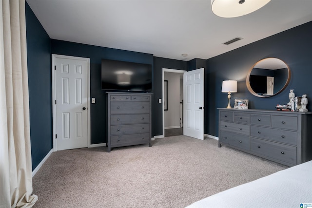 bedroom featuring baseboards, visible vents, and light colored carpet