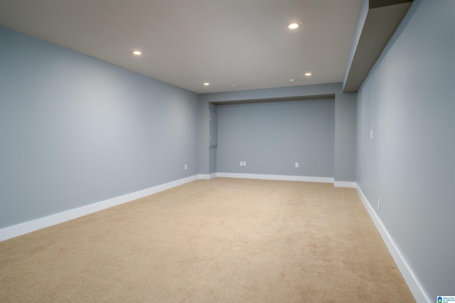 unfurnished room featuring light carpet, baseboards, and recessed lighting