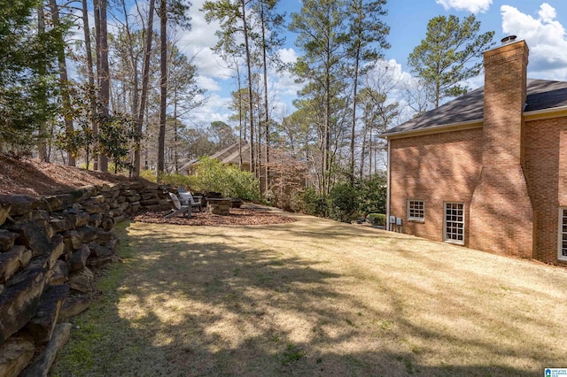 view of yard with an outdoor fire pit