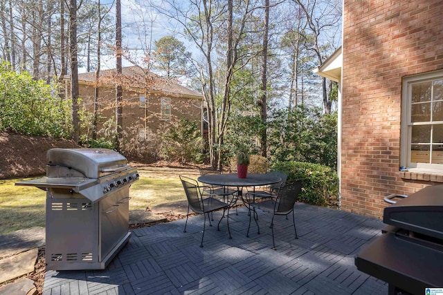 view of patio / terrace featuring outdoor dining space and a grill