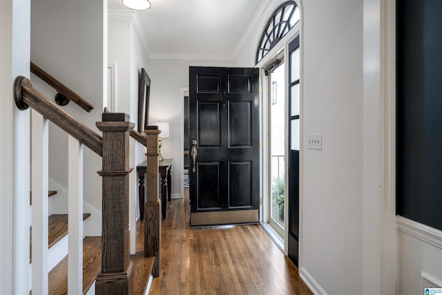 entryway featuring stairway, wood finished floors, and crown molding