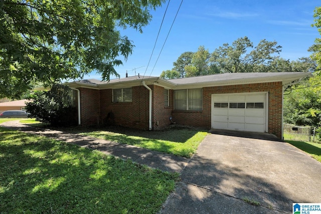 single story home featuring a front yard, concrete driveway, brick siding, and an attached garage