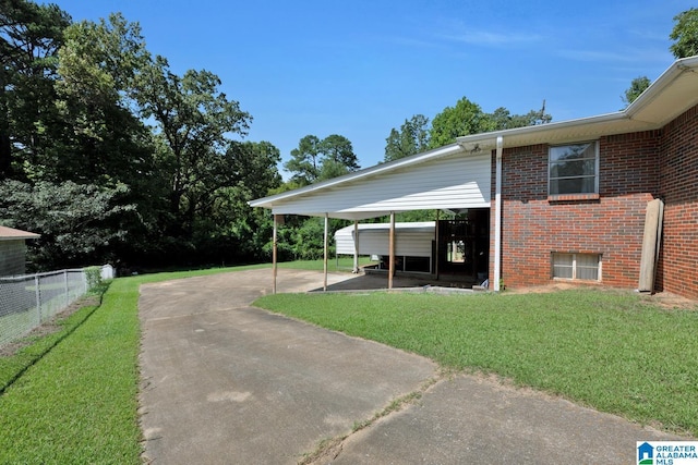 exterior space featuring concrete driveway, a carport, and fence