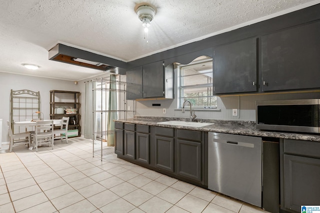 1877 Old Sylacauga Hwy, Sylacauga, AL 35150 - kitchen with light tile patterned floors, appliances with stainless steel finishes, dark stone countertops, a textured ceiling, and a sink