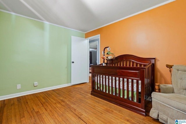 1877 Old Sylacauga Hwy, Sylacauga, AL 35150 - bedroom with ornamental molding, baseboards, a crib, and light wood finished floors